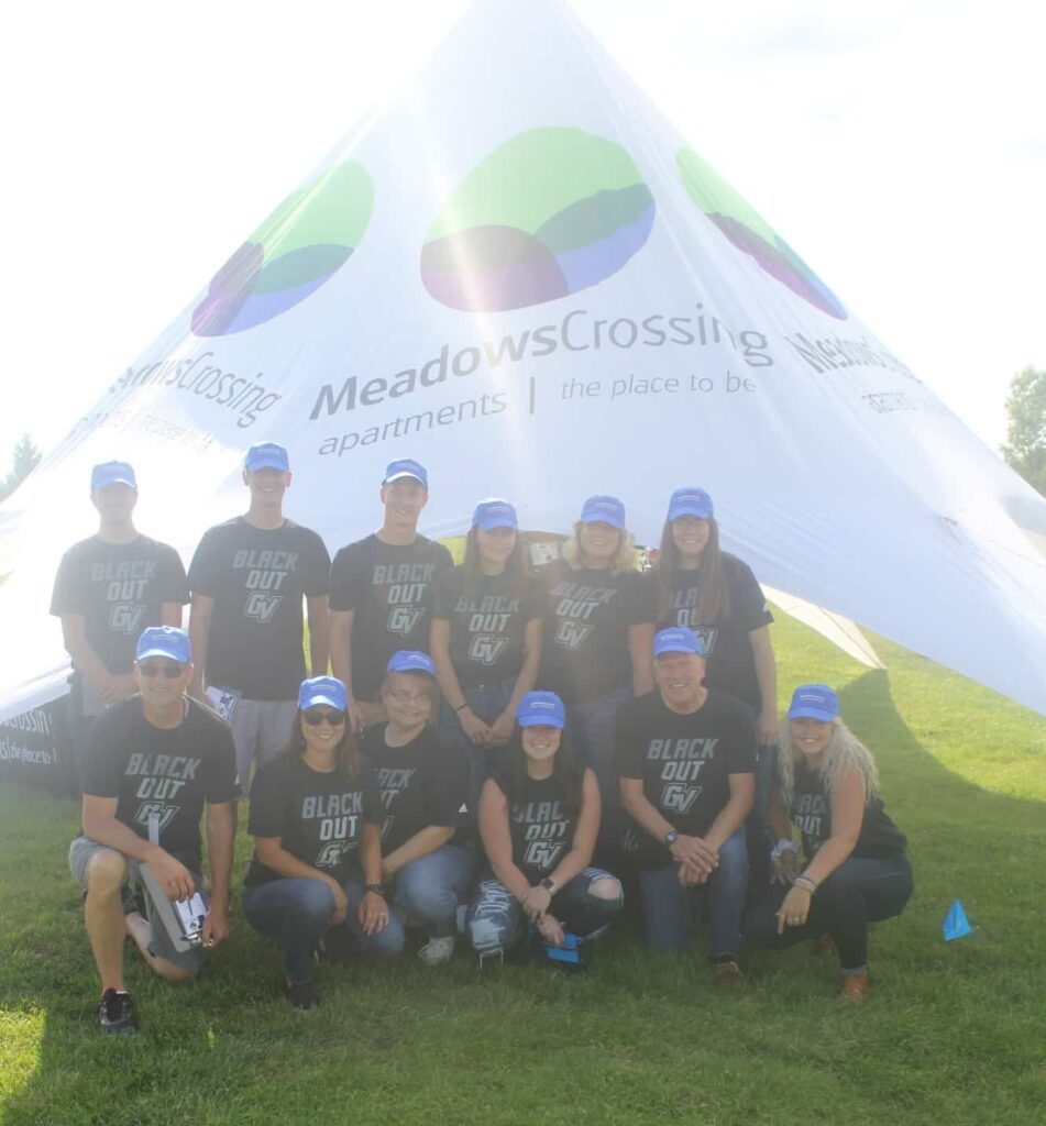 People with Black Out GV shirts under Meadows Crossing tent