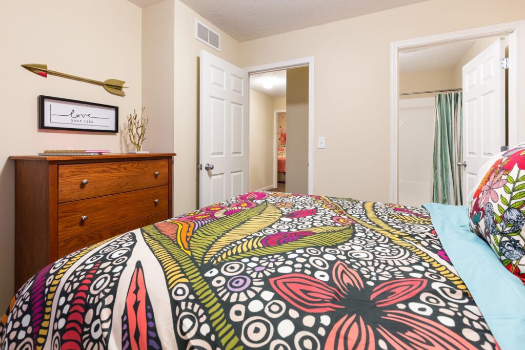 Bedroom showing bathroom doorway and exit to hall area