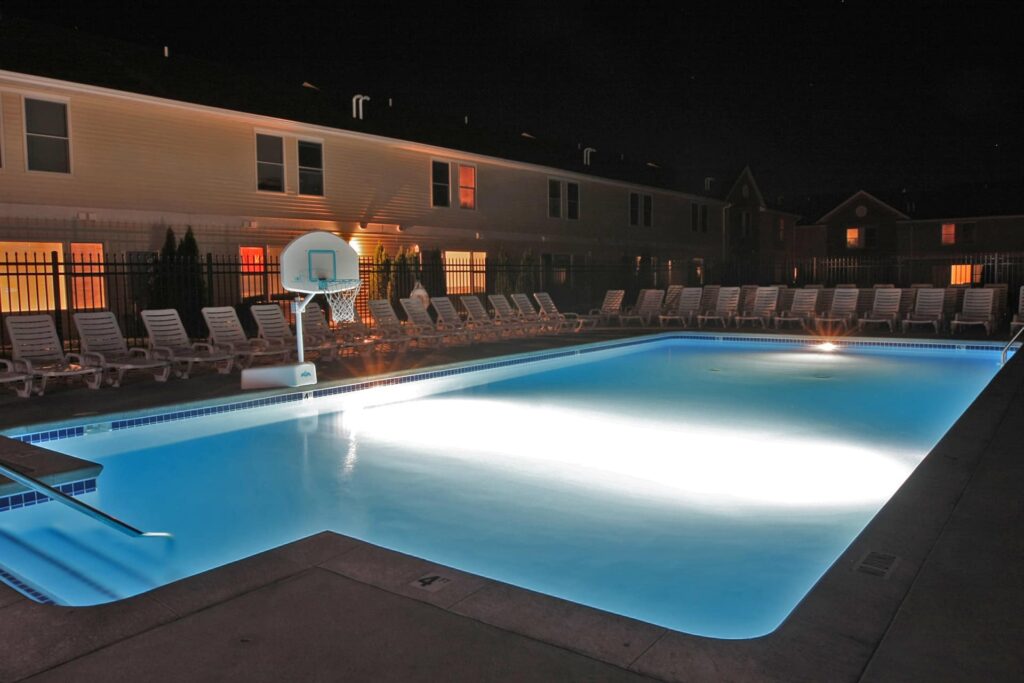 pool area with basketball hoop and chairs