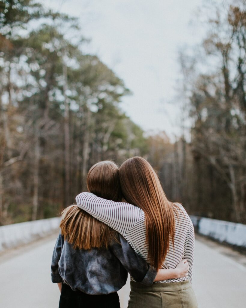 Two friends with arms around each other
