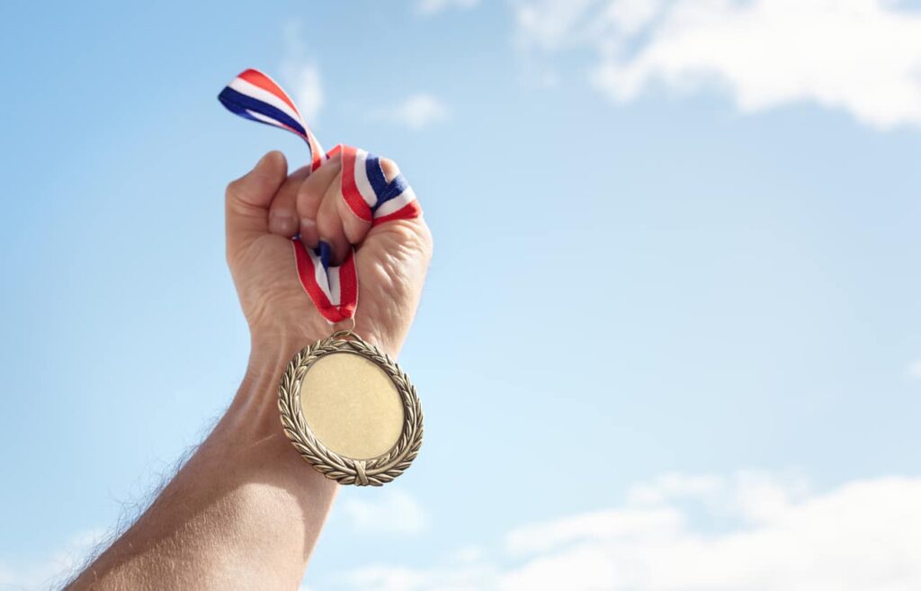 Person holding gold medal