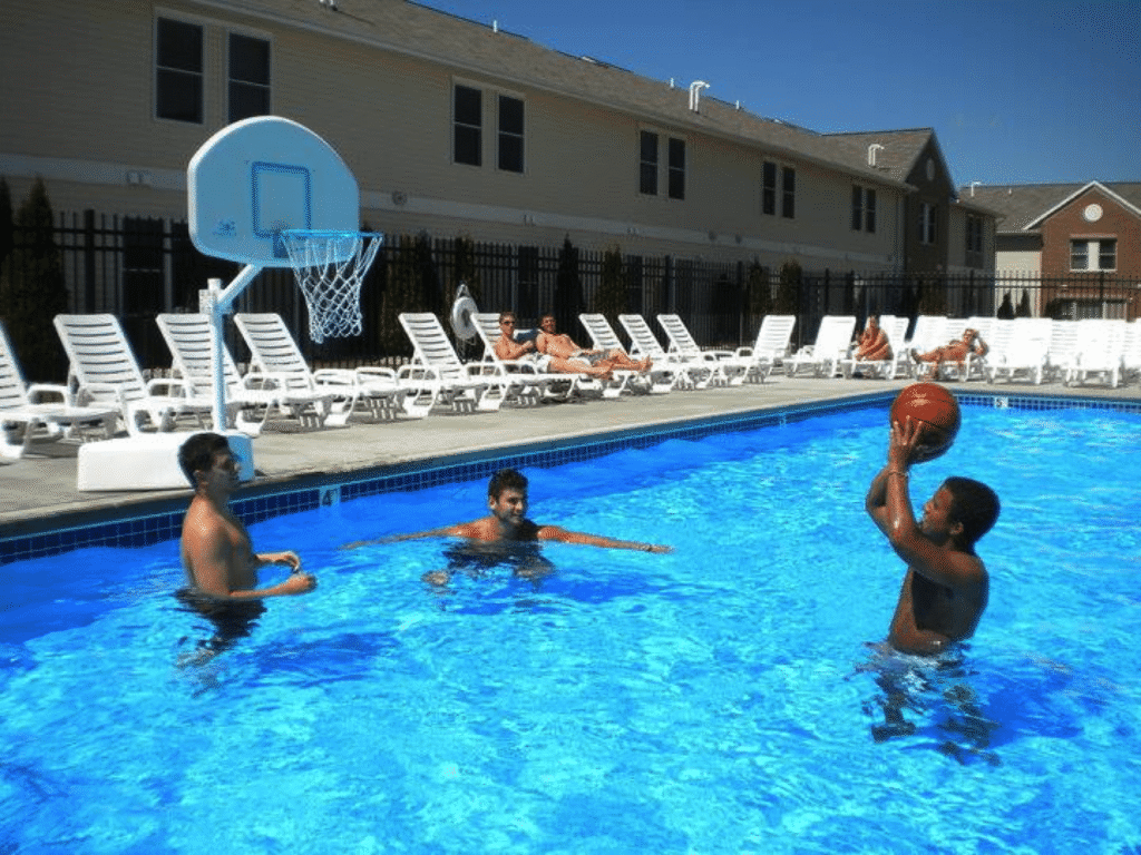 People shooting hoops in the pool