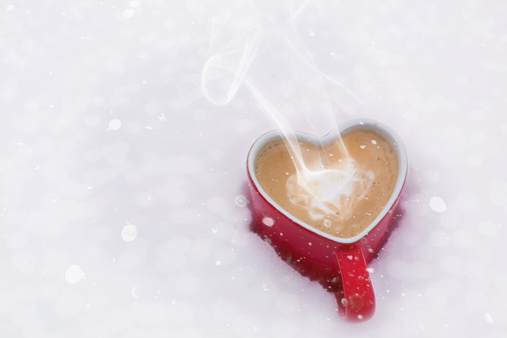 Coffee in heart mug in the snow